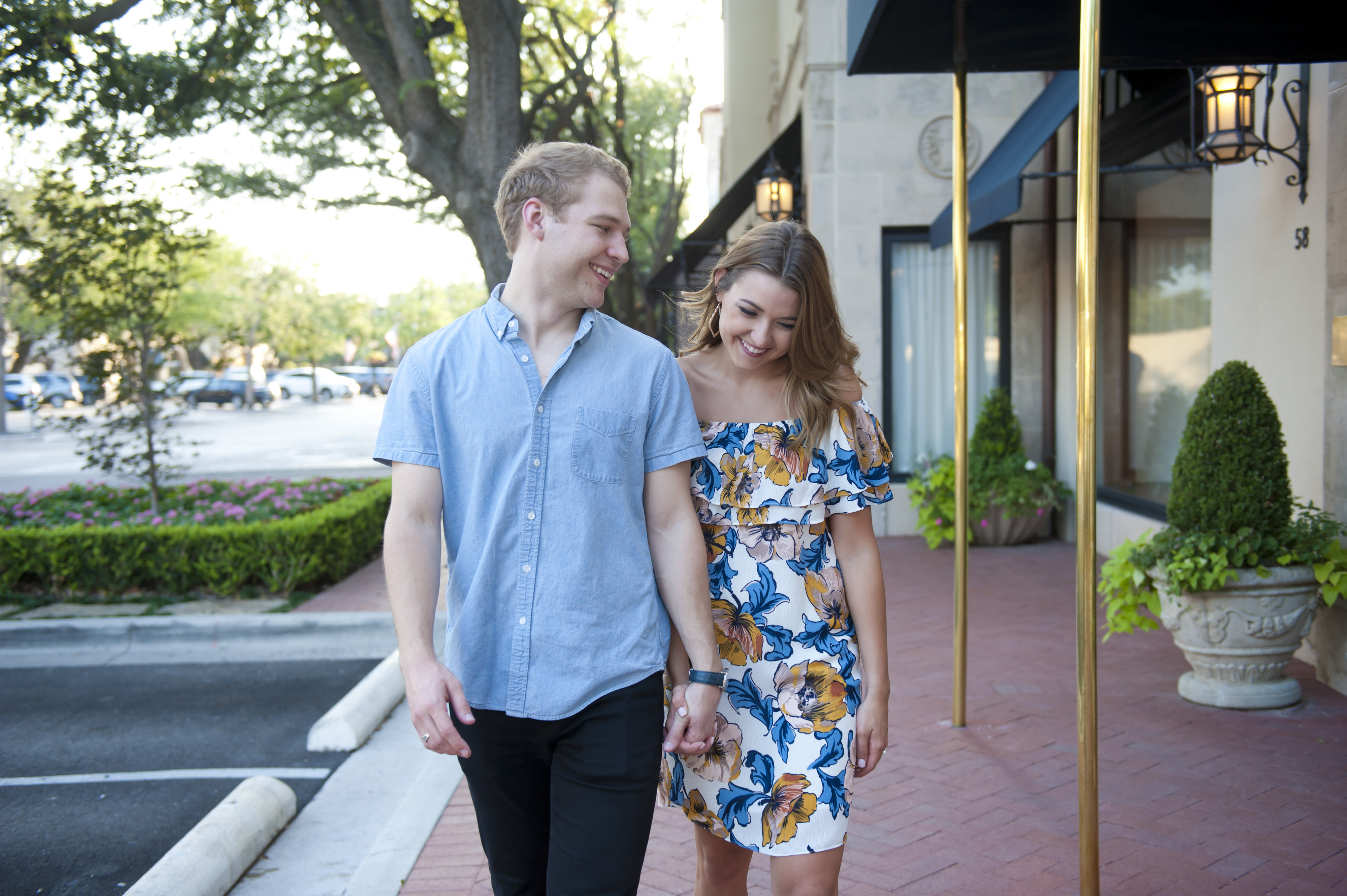 Couple Strolling on City Sidewalk