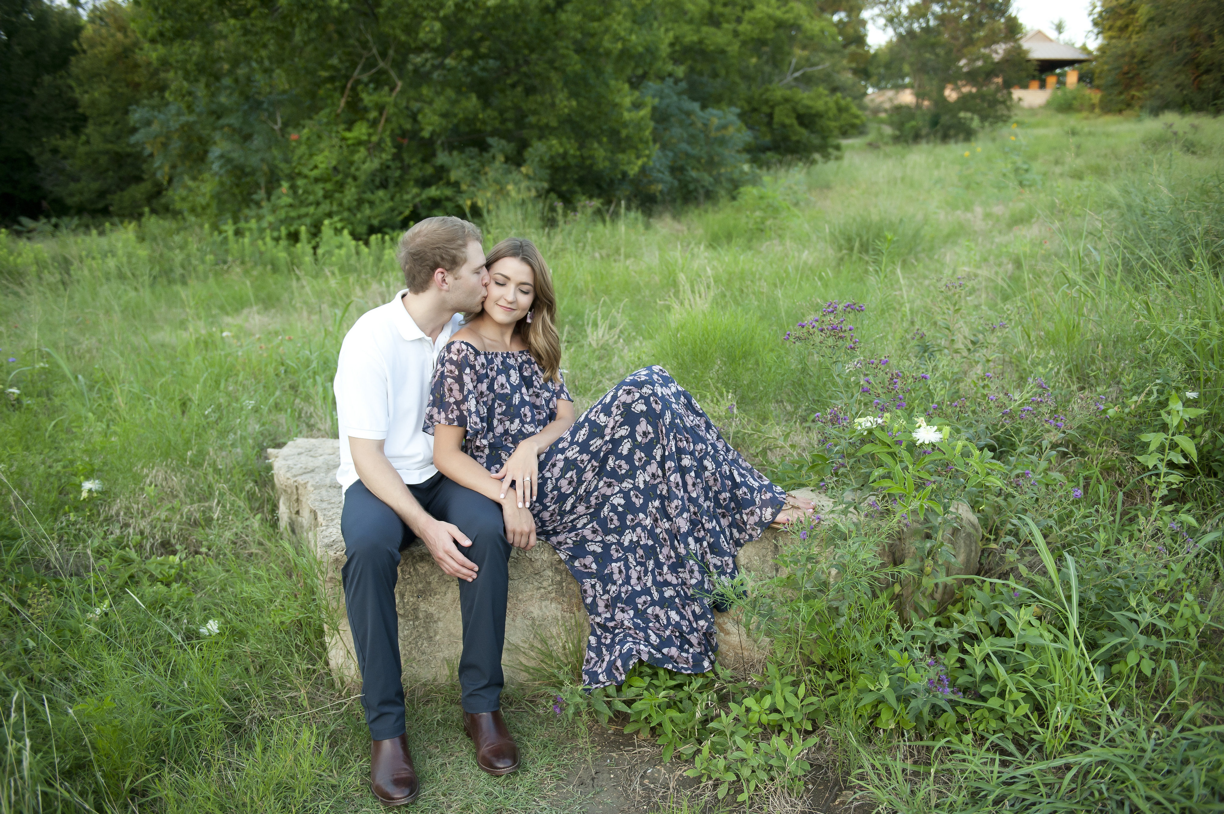 Couple Kissing and Relaxing on a Stone