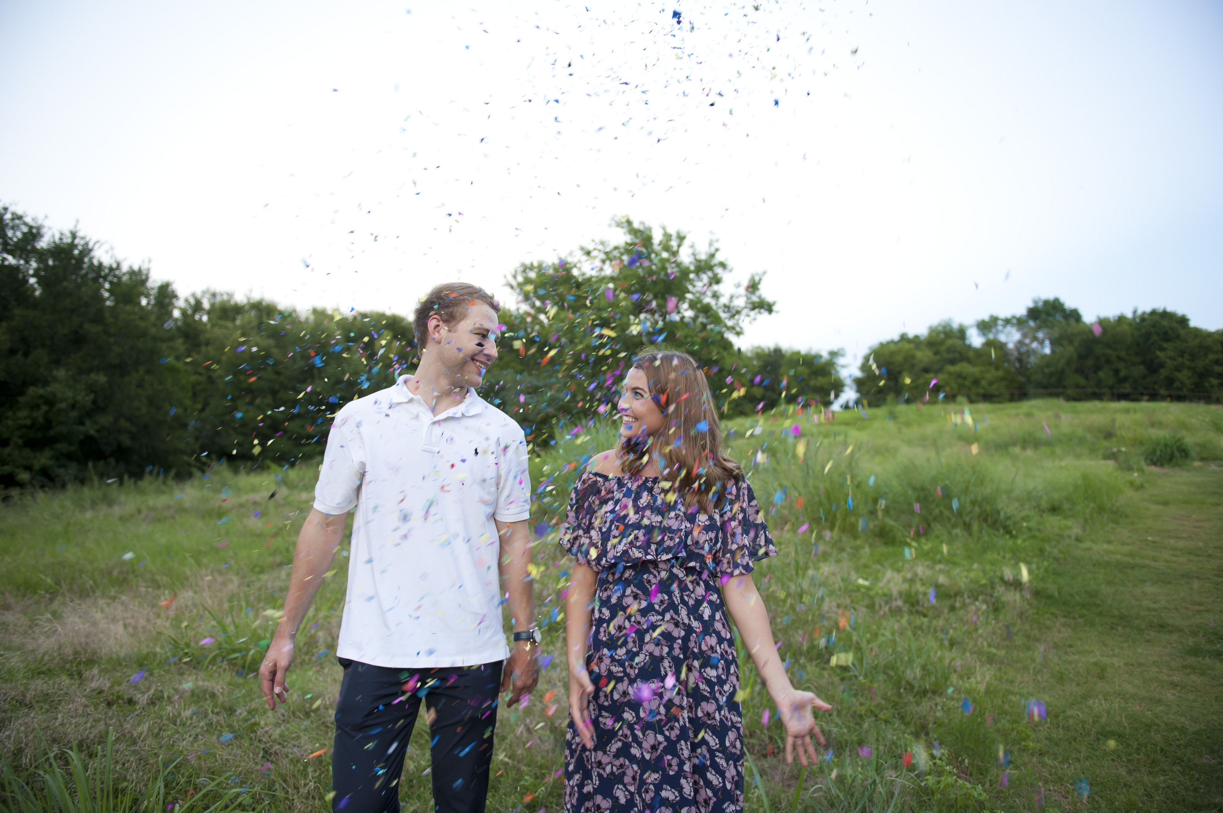 Couple Holding Hands Throwing Confetti