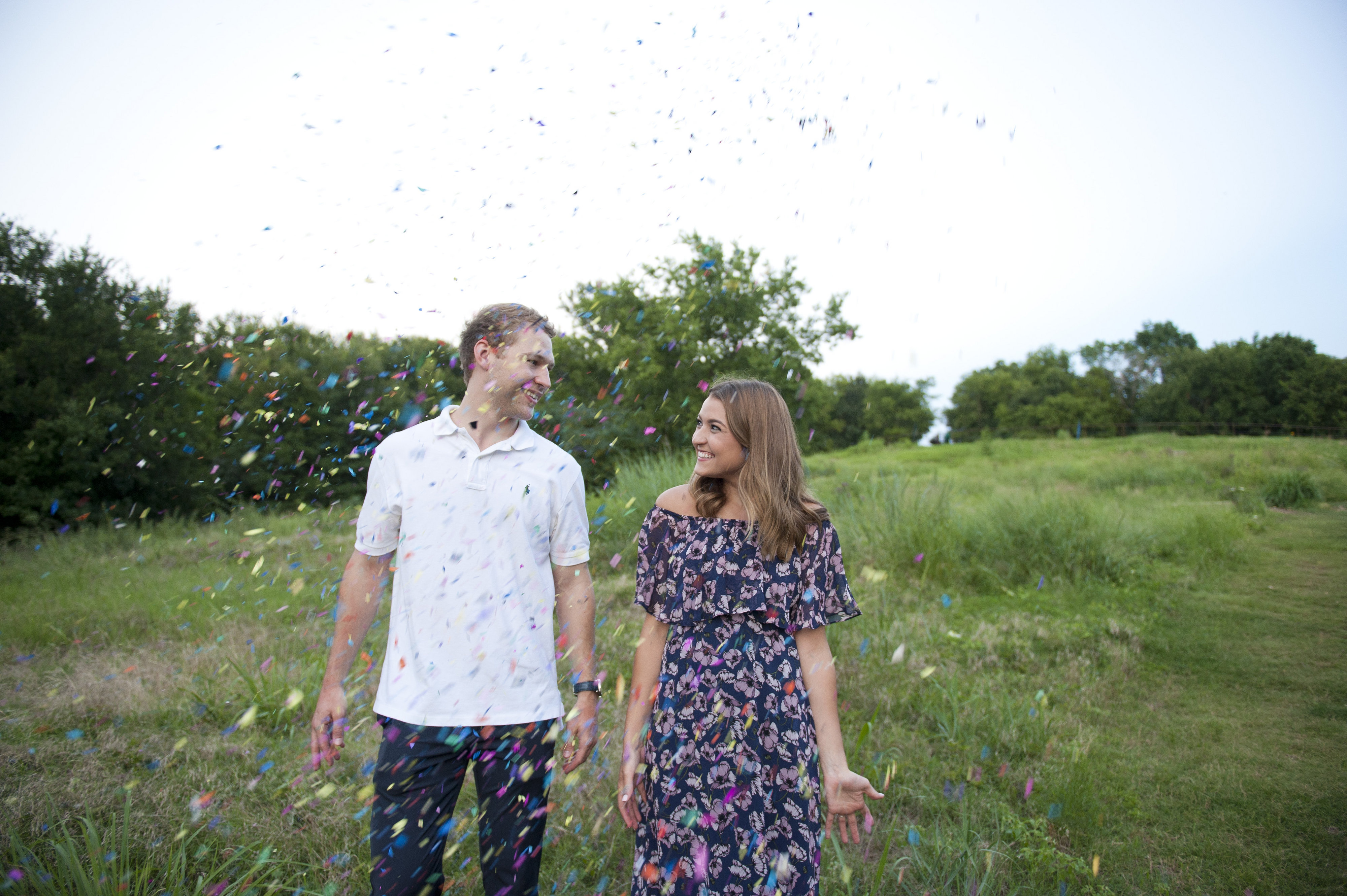 Couple Holding Hands Throwing Confetti